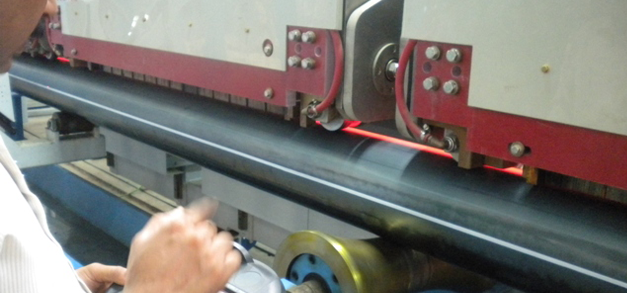 Operator using handheld control unit during seam normalizing process to maximize uptime