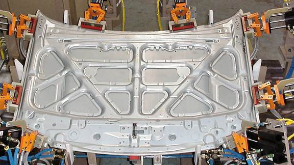 Car body panel undergoing induction bonding in a high-tech automotive assembly station by ENRX