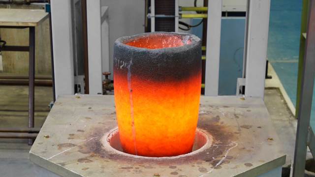 Glowing ceramic crucible heated by an induction system during industrial metal melting