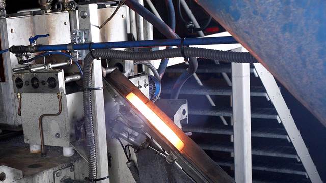 Steel bar heated in an industrial induction forging system using controlled induction heating