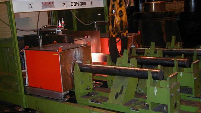 Steel bars heated in an industrial induction forging system using induction heating