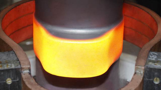 ENRX induction coil applying targeted heat treatment to camshaft surface