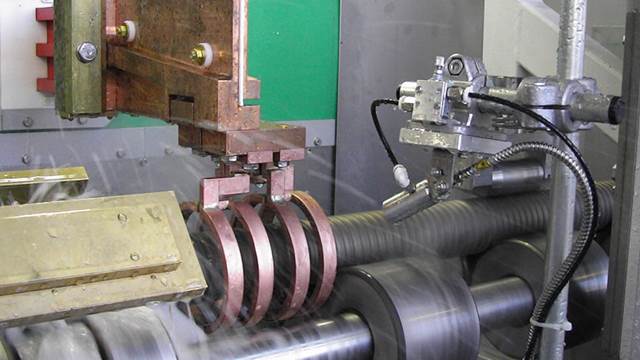 ENRX induction heating system performing precision tempering of steel components in an automated production line