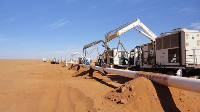 ENRX induction heating equipment performing post weld heat treatment on large pipeline in desert environment