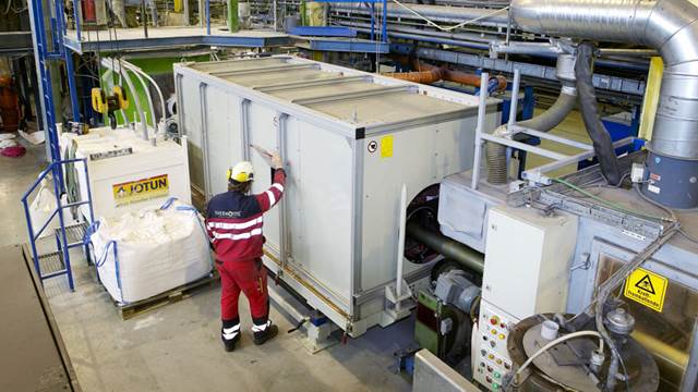 Operator working with ENRX specialized induction heating system for steel strip and wire production