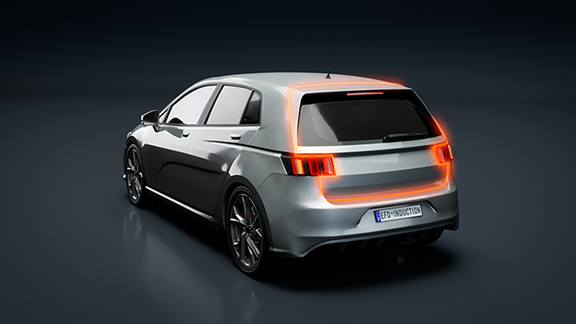 Silver car showing illuminated rear tailgate edges representing induction bonding zones, illustrating ENRX’s precise and efficient heating for automotive tailgate assembly.