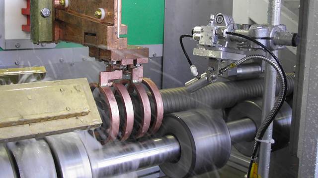 ndustrial induction heating setup where ENRX technology is used for tempering long hardened shafts and cylindrical workpieces