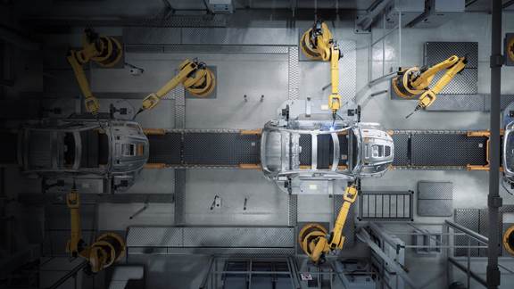 Automotive body shells moving through a robotic assembly line powered by an inductive skillet conveyor system