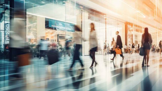 People walking through a modern airport terminal illustrating wireless charging and airport logistics systems