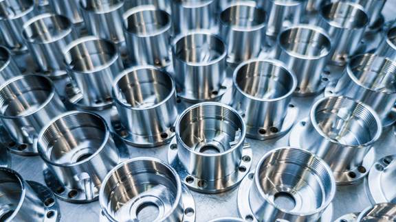 Array of precision-machined metal components, illustrating the controllability and repeatability of induction heating processes at ENRX