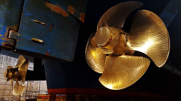Close-up of polished bronze ship propellers representing induction heating for shipbuilding applications