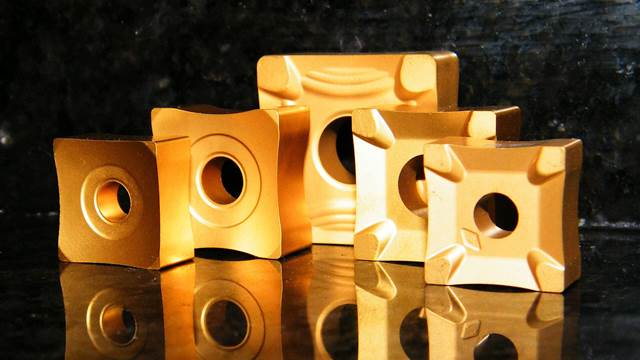 Four ENRX OD scarfing inserts in gold-coated carbide, used as consumables in high-frequency tube and pipe welding