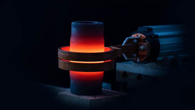 Glowing metal cylinder heated to red-hot temperature inside an ENRX induction heating coil