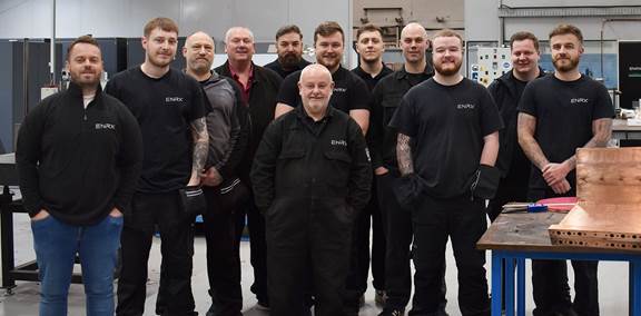 Group photo of the ENRX UK Coil R&D team standing together inside the workshop, representing expertise in induction coil design and manufacturing.