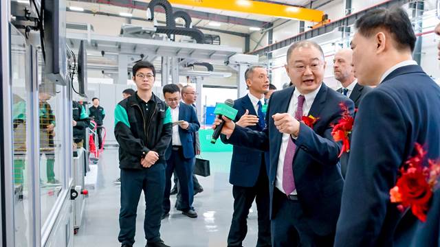 Executives and ENRX team members touring the new ENRX factory in China during the opening event.