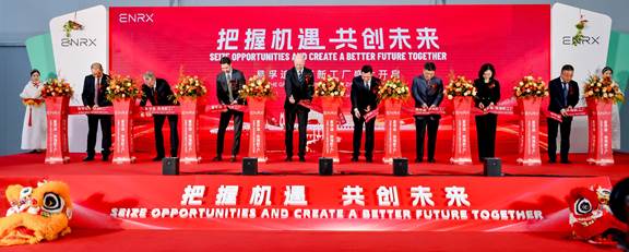 Ribbon-cutting ceremony during the opening of the new ENRX factory in China, with executives and officials on stage.
