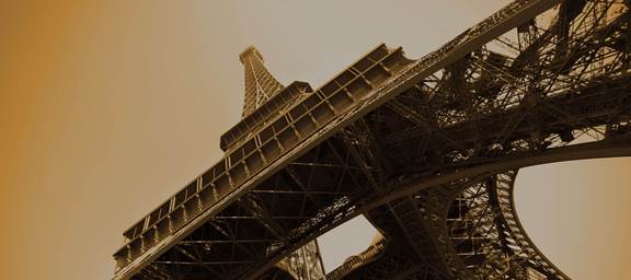Eiffel Tower steel structure viewed from below, symbolizing engineering innovation and modern induction technology