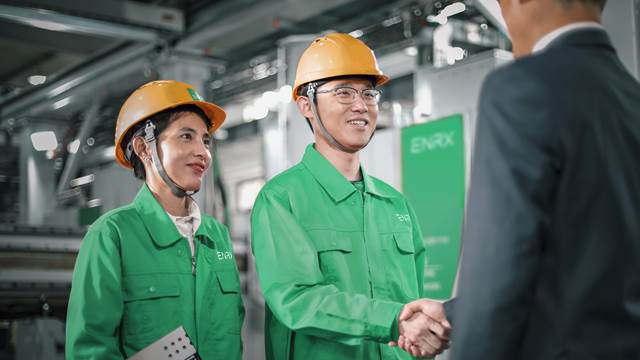ENRX engineers providing commissioning and start-up assistance, greeting a customer at an industrial installation site.