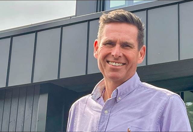 Portrait of the Managing Director of ENRX USA standing outside a modern building.