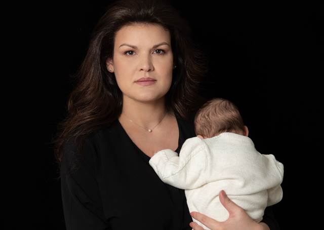 Carmen Sisu, Managing Director of ENRX Romania, holding her baby — representing leadership, work–life balance, and ENRX’s supportive company culture.