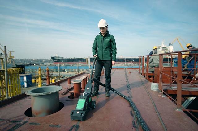 Operator using Terac induction system for deck straightening and weld distortion correction in shipyard